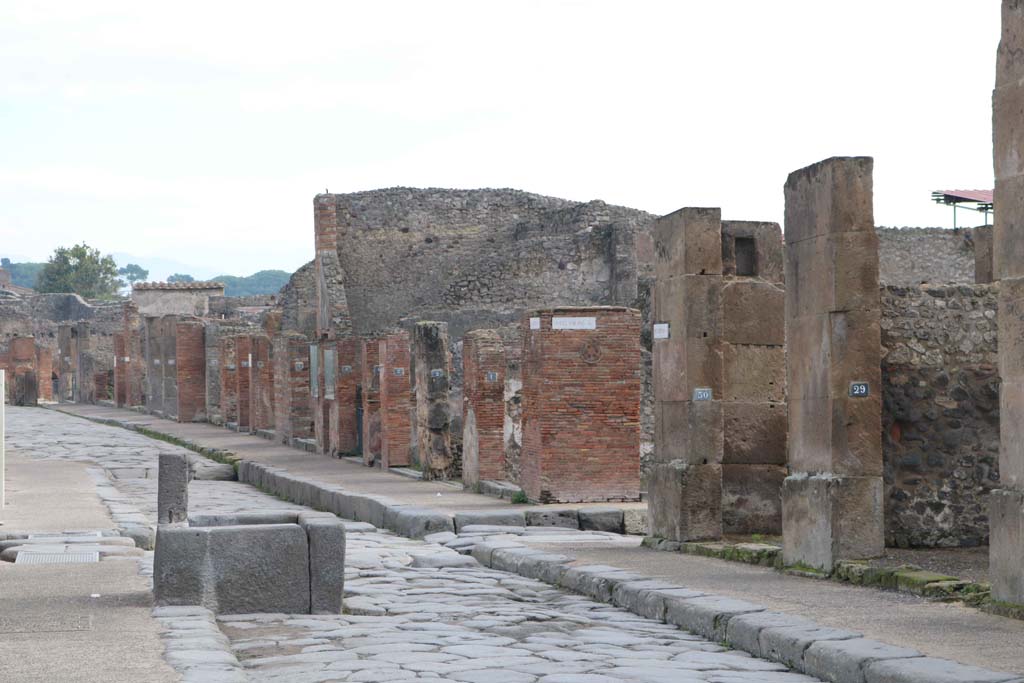 Fountain outside VII.14.13 and VII.14.14 on Via dellAbbondanza, south side, Pompeii. December 2018. 
Looking east towards junction with Via dei Teatri, and Insula VIII.4, on left and VIII.5, on right. Photo courtesy of Aude Durand.

