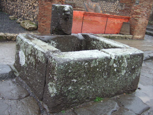 Fountain outside VII.14.13 and VII.14.14 on Via dell’Abbondanza. December 2005.
Head with helmet, possible relief of Minerva.