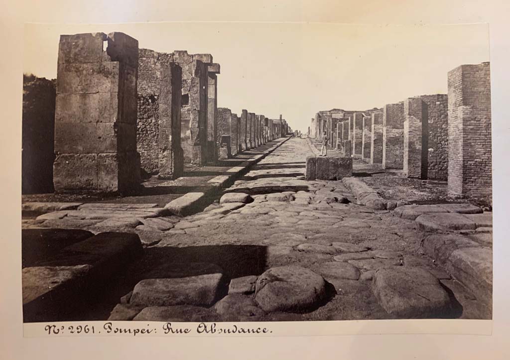 Fountain outside VII.14.13 and VII.14.14 on Via dellAbbondanza. From an album of Michele Amodio dated 1874, entitled Pompei, destroyed on 23 November 79, discovered in 1748. 
Looking west to crossroads with Via dei Teatri, on left, and Vicolo del Lupanare, on right.
Photo courtesy of Rick Bauer.
