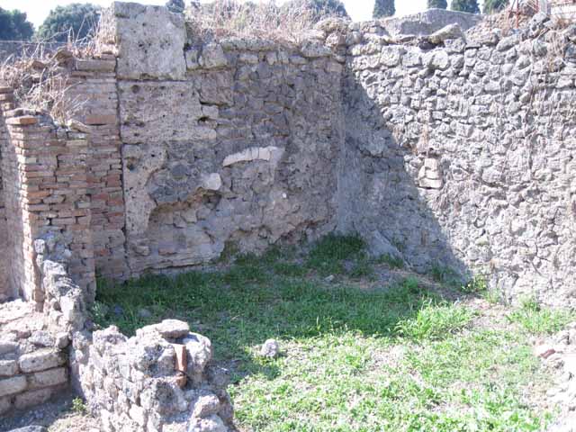 I.1.8 Pompeii. September 2010. Doorway to room on north side of yard, possibly a dormitory. The remains of the steps to upper floor are on the left of the photo. Photo courtesy of Drew Baker.
