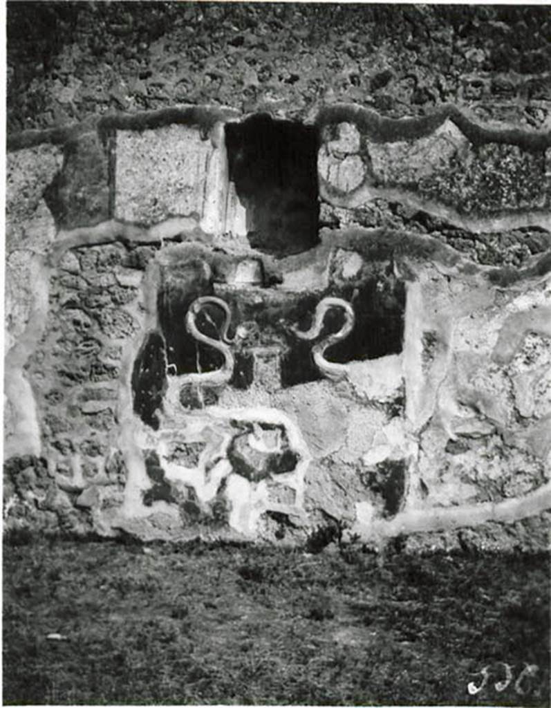 I.2.3 Pompeii. 1912 photo by Tatiana Warscher.
Lararium in the south wall of the atrium.
Warscher noted that the photo was taken by her in 1912 (on her honeymoon!).
When writing the DAIR copy of the Codex (1935) she wrote –
“Adesso i serpenti sono in uno stato peggiore. Il Genio familiare con patera e cornucopia non esisteva già nell’anno 1912”.
(translation: “Now the serpents are in a bad state. The Genius with plate and cornucopia did not exist even by 1912”.)
See Warscher T., 1935. Codex Topographicus Pompeianus: Regio I.2. (no.3), Rome: DAIR, whose copyright it remains.       
