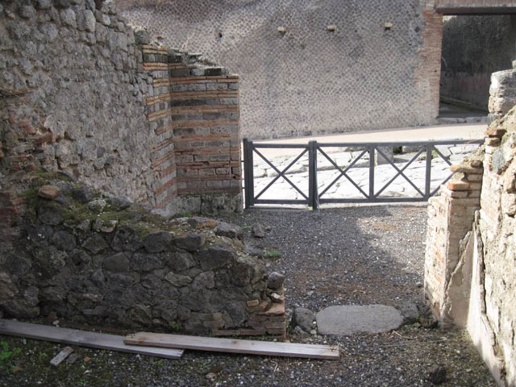 I.3.1 Pompeii. September 2010. West wall and doorway of small room, looking towards entrance from Via Stabiana, and west wall of bakery room. Photo courtesy of Drew Baker.
