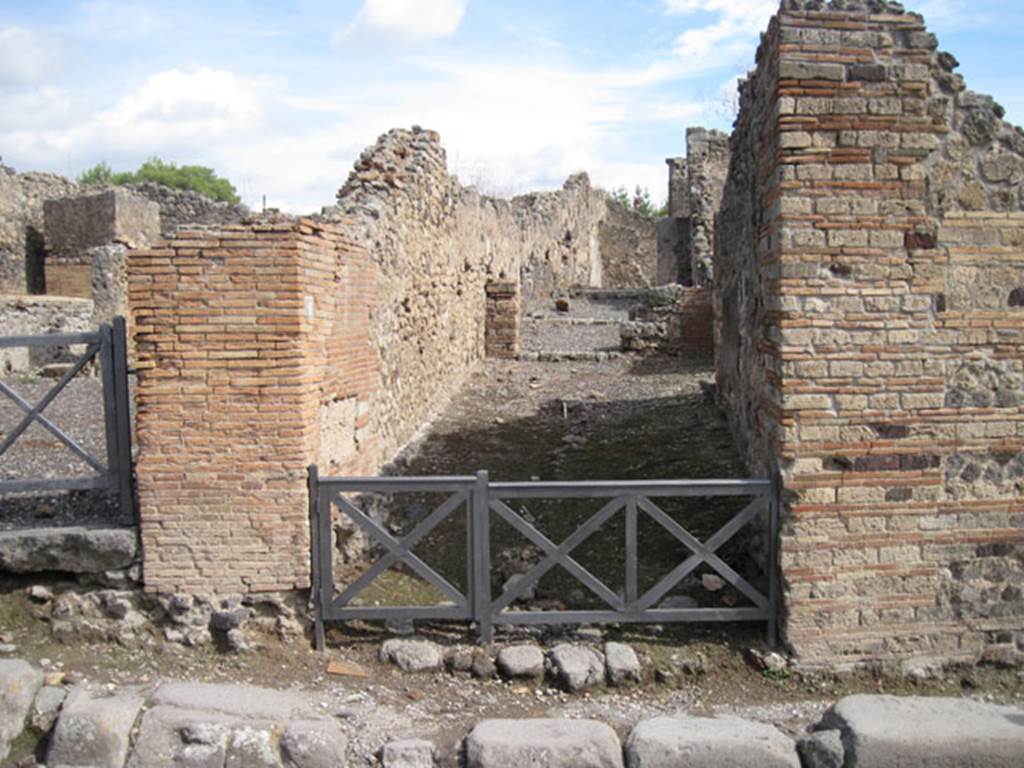 I.3.8 Pompeii. September 2010. Looking east from across via Stabiana towards entrance to angiportus or alleyway. This angiportus provides access to two distinctly separate houses. I.3.8a with entrance on right of main corridor. I.3.8b House of Vulcanus with entrance straight ahead. Photo courtesy of Drew Baker.