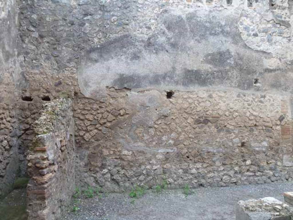 I.4.27 Pompeii. May 2010. West wall of front bar or sales-room, with latrine in the south-west corner.