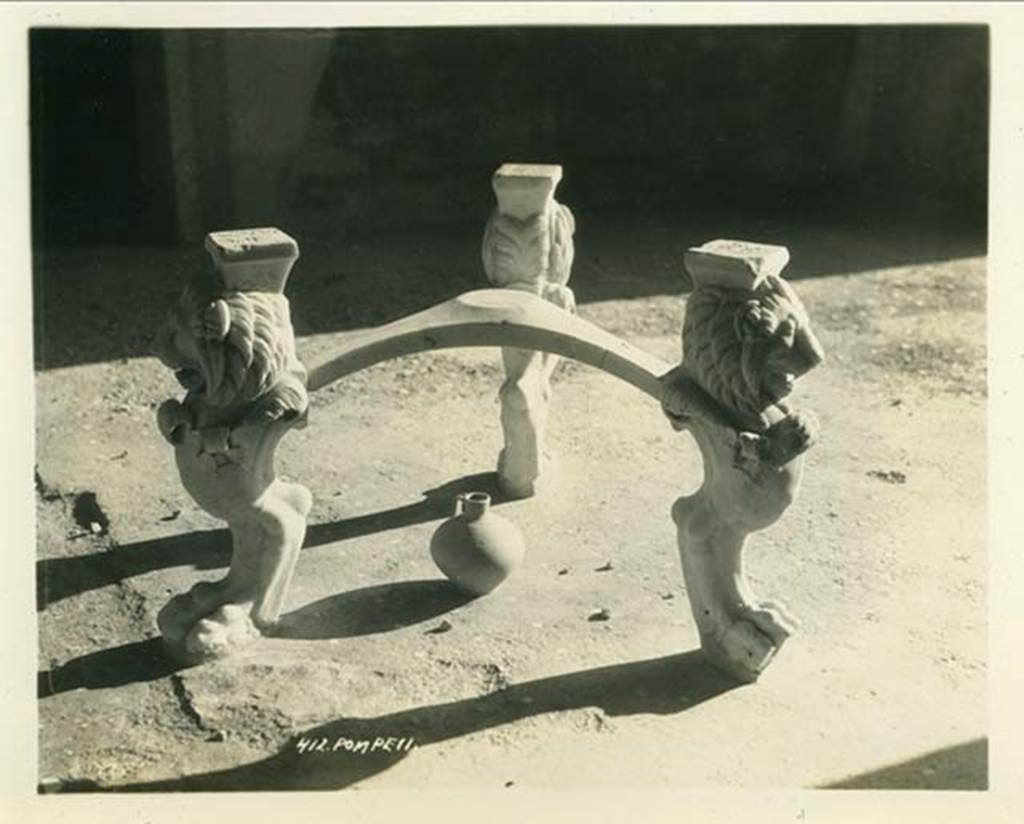 I.6.11 Pompeii. 1932. Marble tripod table legs with lion heads and paws, in atrium. Photo taken during a shore-visit from the ship Resolute’s world cruise in 1932. Photo courtesy of Rick Bauer.
