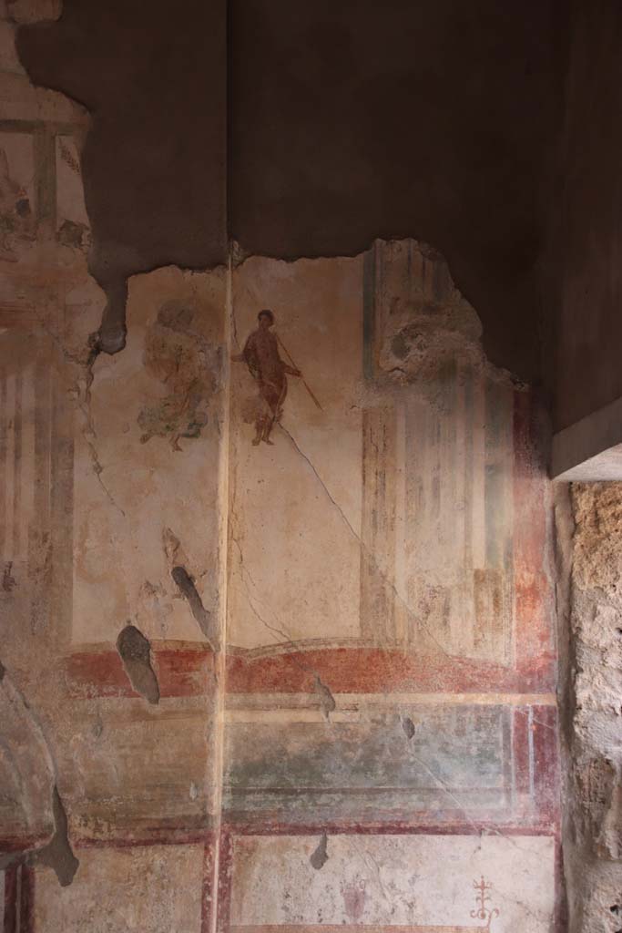 I.7.11 Pompeii. September 2021. 
Detail of painted decoration on west side of central painting on north wall of triclinium. Photo courtesy of Klaus Heese.
