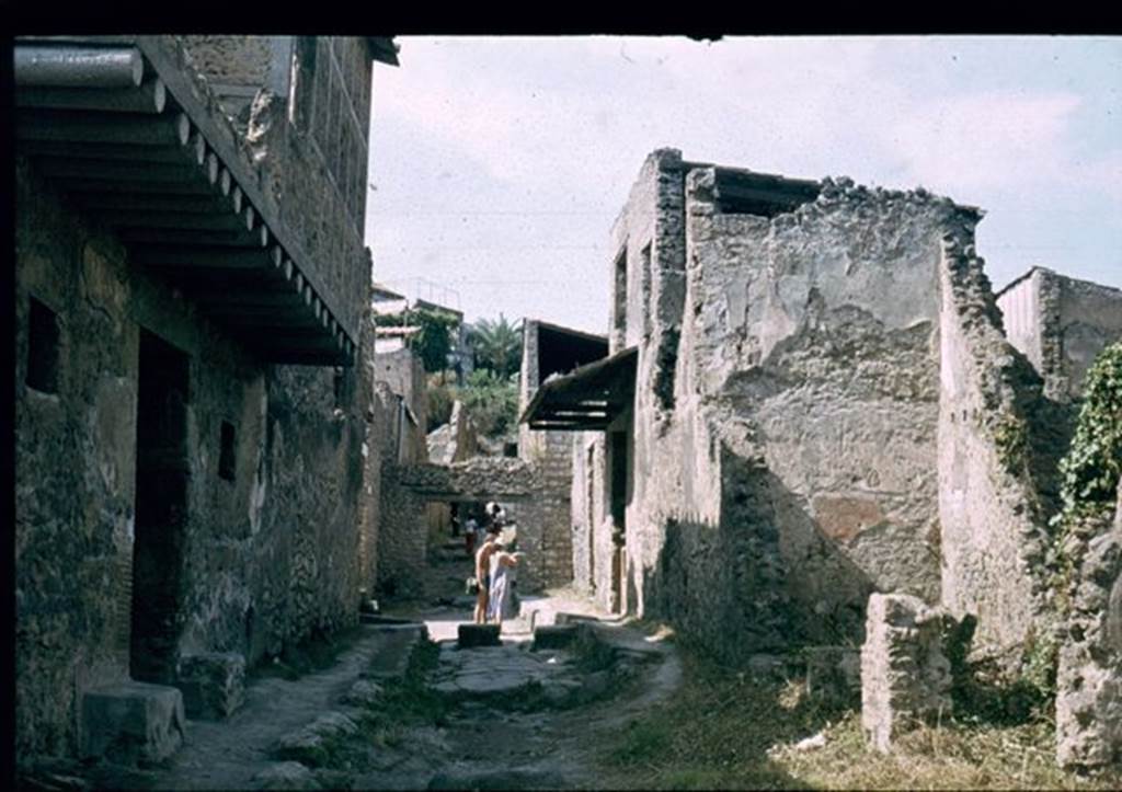 I.7.17 Pompeii, on right, together with I.7.16. Looking north along Vicolo di Paquius Proculus. I.10.18 is on the left. 
Photographed 1970-79 by Gnther Einhorn, picture courtesy of his son Ralf Einhorn.

