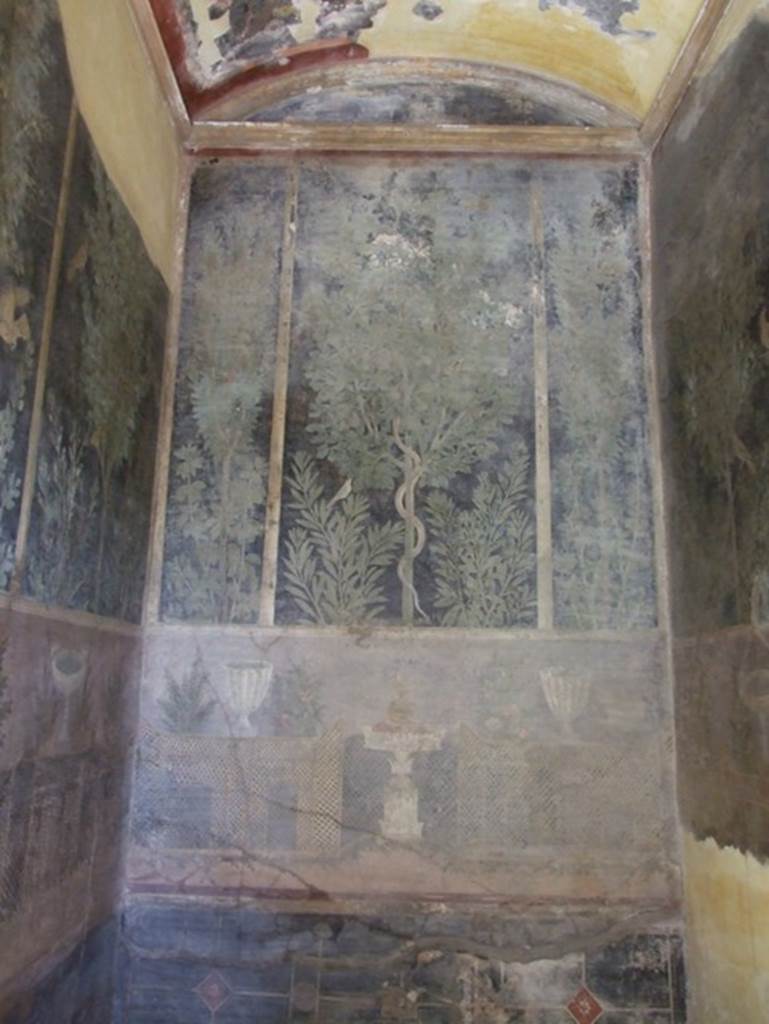I.9.5 Pompeii. March 2009. Room 11.Cubiculum. East wall.  Garden painting with serpent in a fig tree, lattice fencing, white vases and table with Isis cup or jar