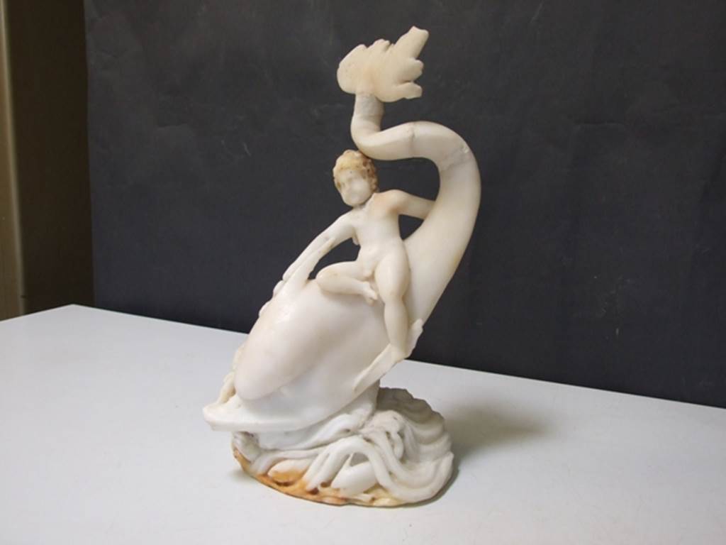 I.9.14 Pompeii.  Marble fountain statuette.  Amorino on dolphin with octopus.  SAP inventory number 8126.  Found in 1951.