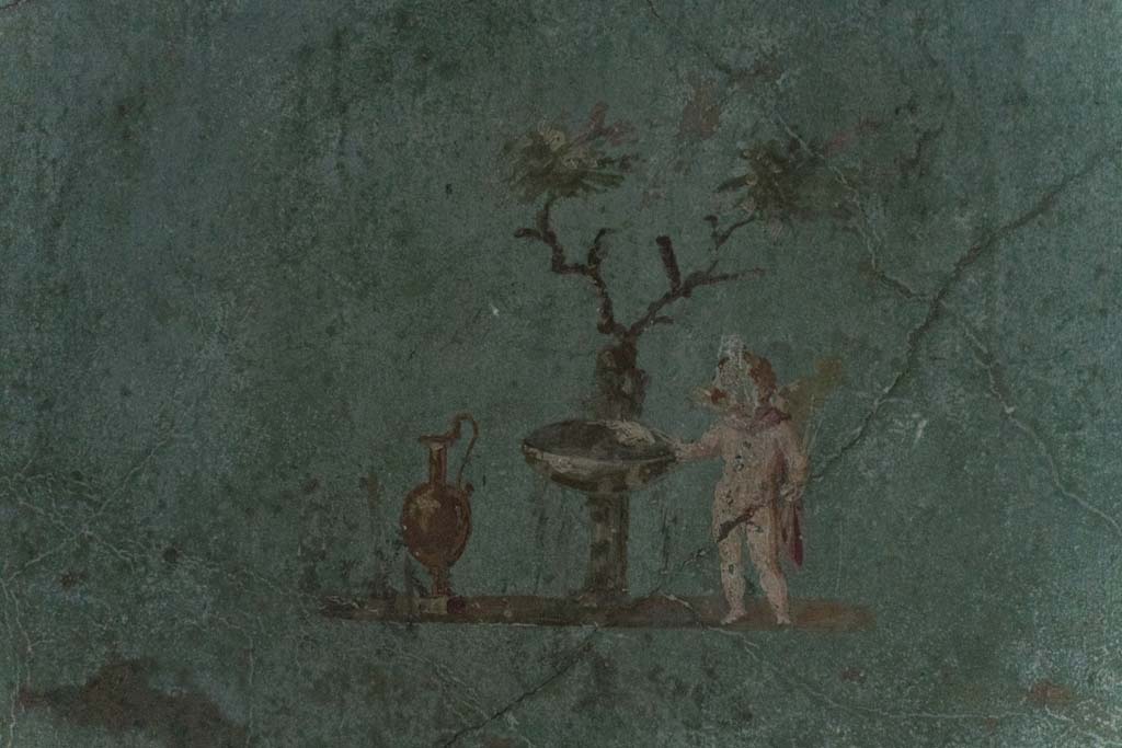 I.10.4 Pompeii. April 2022. 
Room 48, painted cupid with jug, fountain basin and tree in rectangular recess. Photo courtesy of Johannes Eber.

