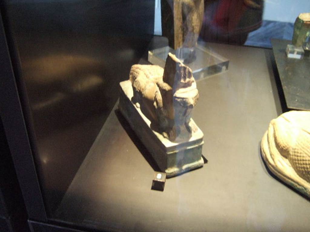 I.12.6 Pompeii. Found September 1960 on the podium of the kitchen in the south-west corner of the peristyle.
In December 2006 this statuette was in Naples Museum.
It was described on the case label as a crocodile with a hawks head, found in I.12.6. 
Now in Naples Archaeological Museum. 
According to Di Gioia, it is an Iguana and has the SAP Inventory number 12960.
See Di Gioia E., 2006. La ceramica invetriata in area vesuviana: SAP studi 19. Roma: LErma di Bretschneider, p. 127, no. 10.
