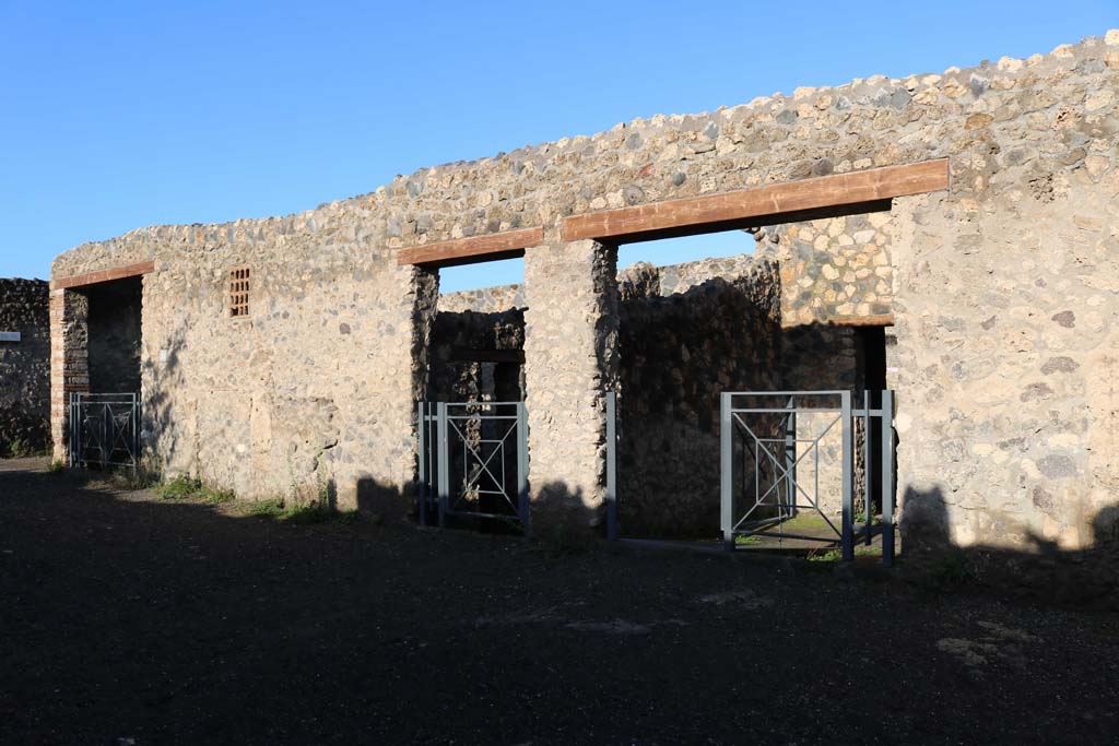 I.14.11, on left, I.14.12, centre, and I.14.13 on right, Pompeii. December 2018. 
Looking north to entrance doorways. Photo courtesy of Aude Durand.
