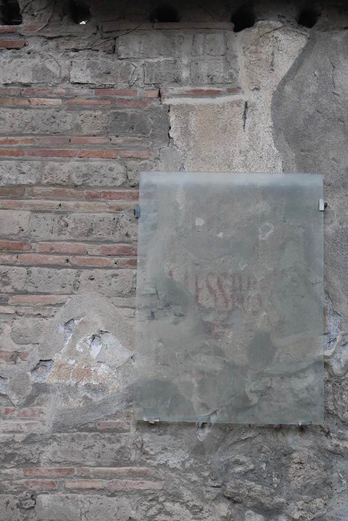 Via di Castricio, September 2018. Photo courtesy of Aude Durand.
Graffito on wall between II.3.8 and II.3.9, found to the east of the painting above. 
According to Epigraphik-Datenbank Clauss/Slaby (See www.manfredclauss.de) it read:
Messius    [CIL IV 7573]
See Varone, A. and Stefani, G., 2009. Titulorum Pictorum Pompeianorum, Rome: Lerma di Bretschneider, (p.207-8)

