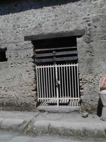 II.9.2 Pompeii. May 2010. Drainage in pavement of Via di Nocera, outside entrance doorway.