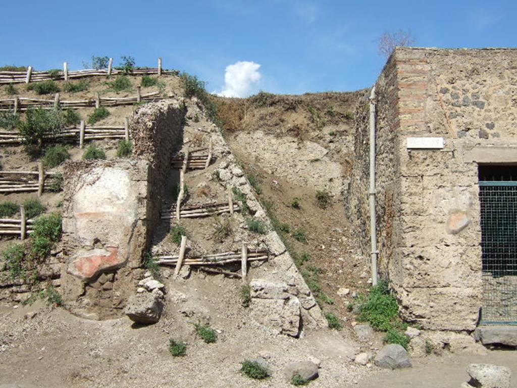 III.5.5 Pompeii. September 2005. Blocked unexcavated roadway, looking north.  III.6.1. In the 1943 bombing, one bomb fell in Via dellAbbondanza close to the SE corner of the insula III.5.