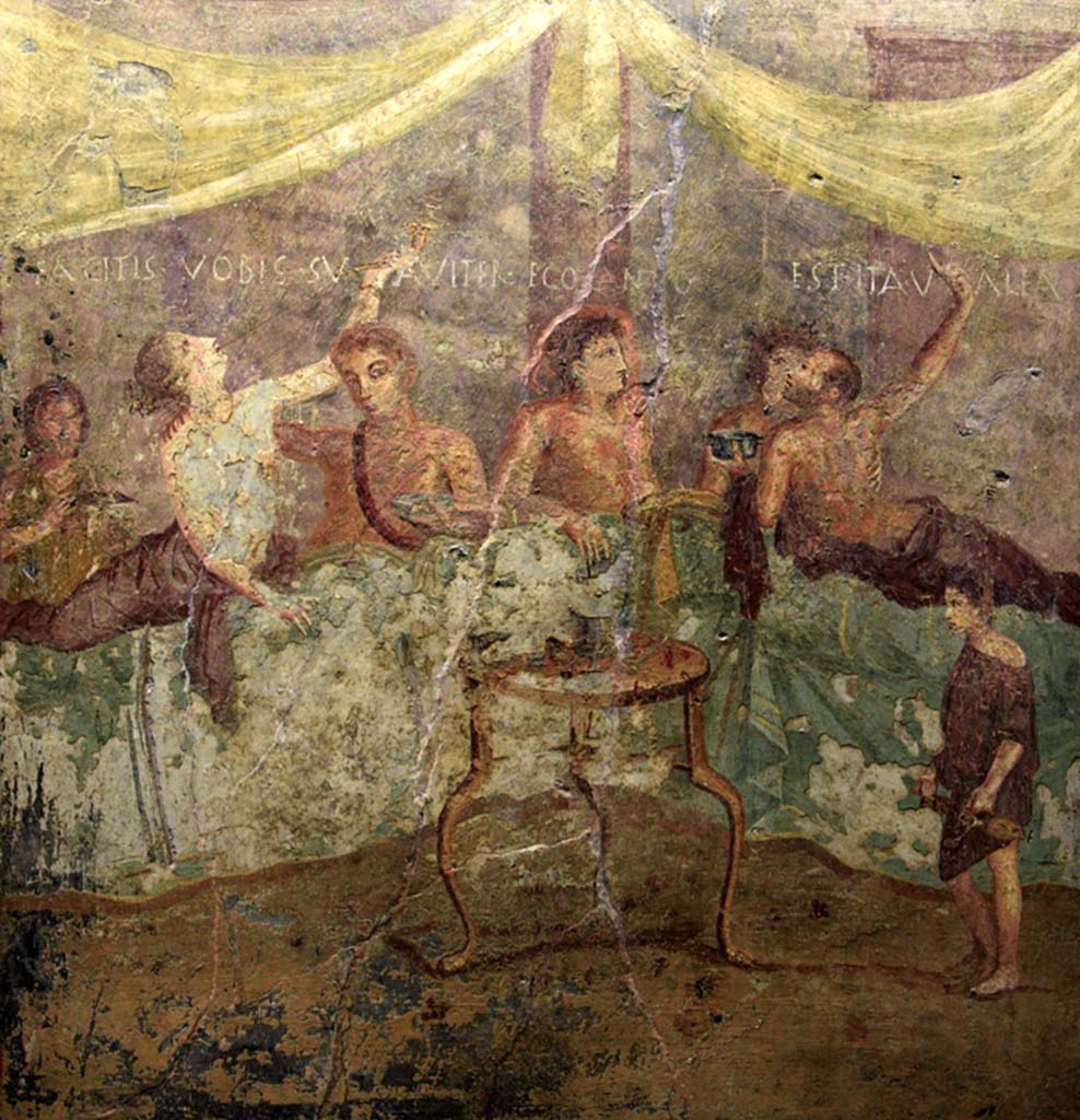 V.2.4 Pompeii. June 2017. Room 15, painting of banqueting scene from north wall of triclinium showing the Commencement. 
The guests are reclining at table and a boy brings in dishes. Photo courtesy of Johannes Eber.
