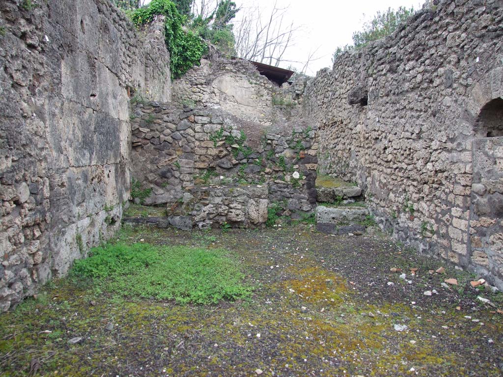 V.3.3 Pompeii. May 2010. Looking north across shop.
According to Boyce, although this shop and dwelling did not appear to have a shrine, somewhere in this area was found a bronze statuette of Fortuna.
She was wearing the modius on her head and holding a cornucopia against her left shoulder.
He quoted the reference Not. Scavi, 1887, 246.
See Boyce G. K., 1937. Corpus of the Lararia of Pompeii. Rome: MAAR 14. (p.108, no.1).
