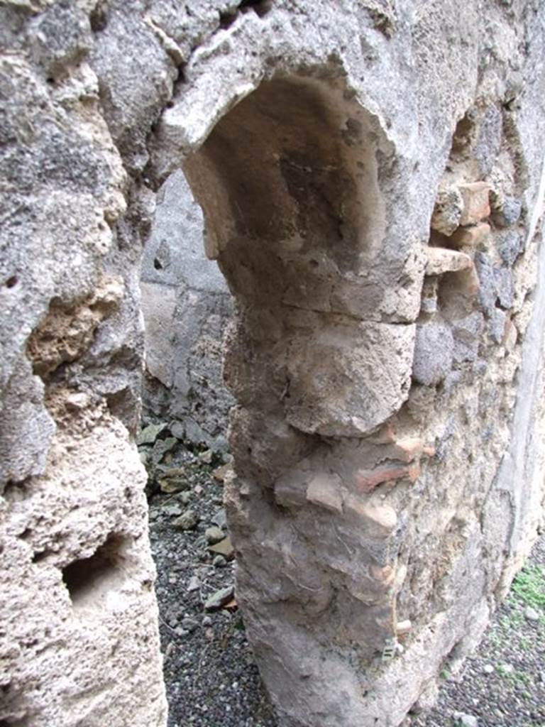 V.3.8 Pompeii.  December 2007.  Arched doorway into latrine on east side of andron.