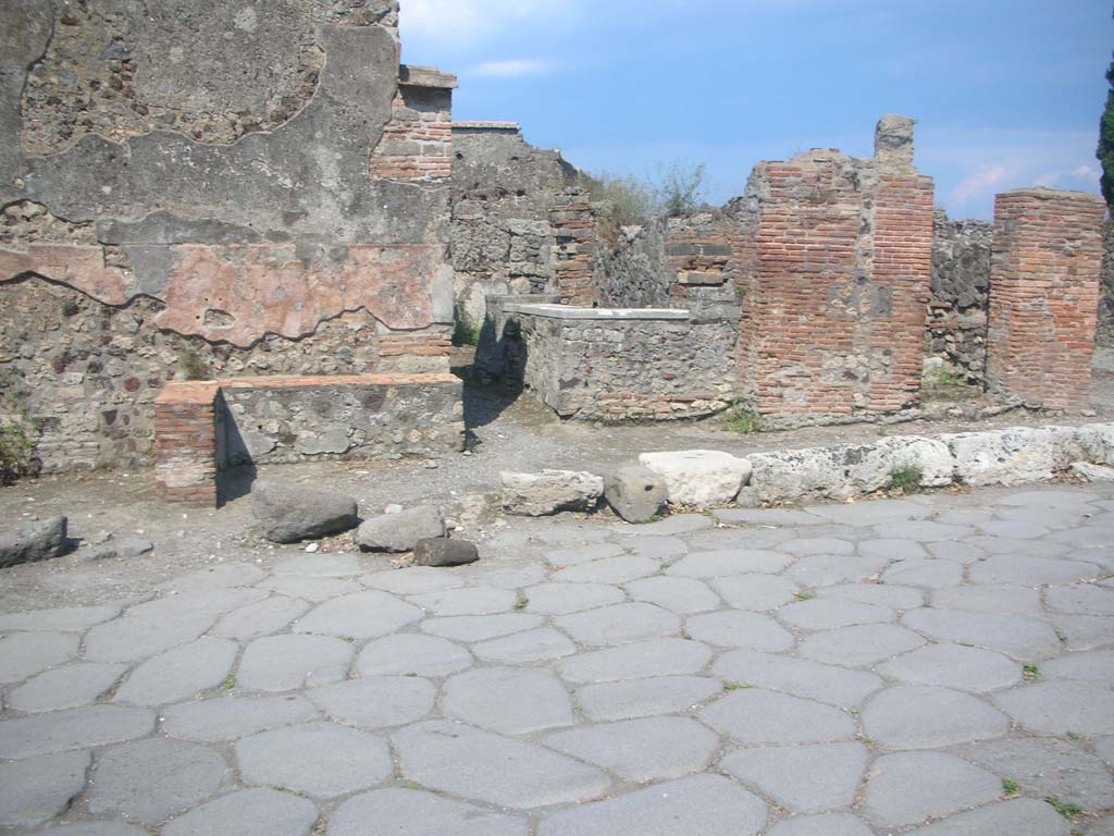 VI.1.3 Pompeii, on right. May 2010. 
Looking east across Via Consolare, with entrance at VI.1.2, in centre. Photo courtesy of Ivo van der Graaff.

