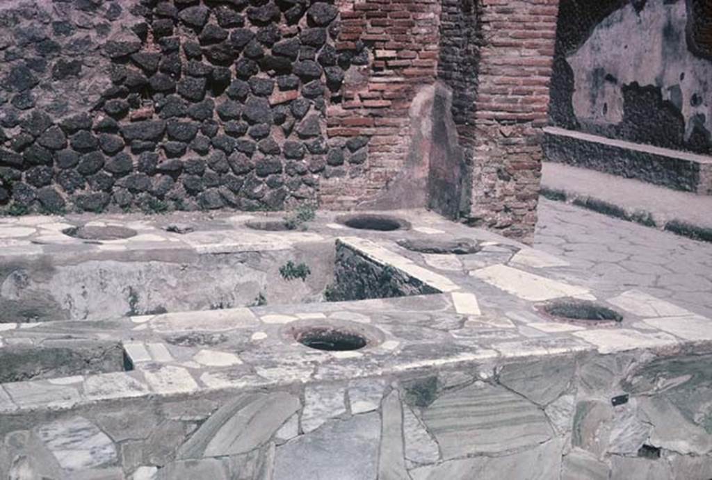 VI.8.8, Pompeii. August 1965. Looking south-east across the counter, on the opposite side of the Via delle Terme can be seen a bench outside the Forum Baths. Photo courtesy of Rick Bauer.
