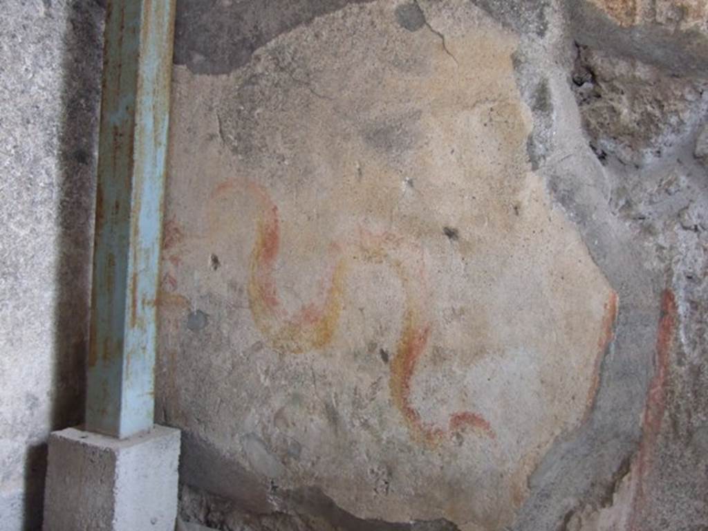 VI.9.7 Pompeii. March 2009. Room 4, painted lararium on north wall, in north-west corner of kitchen.  According to Boyce, in the north-west corner above the hearth is a painting of two red and yellow serpents. The one on the right has red crest and beard; the head of the other is destroyed.
They approach an altar. There are garlands above. See Boyce G. K., 1937. Corpus of the Lararia of Pompeii. Rome: MAAR 14.  (p.50, 178)
