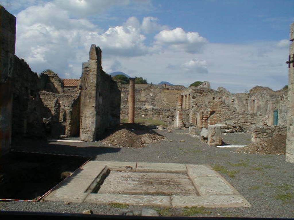 VI.13.6 Pompeii. September 2004. Looking north across atrium, from entrance.
According to Garcia y Garcia, in 1943 a bomb destroyed the rear entrance at VI.13.9.
The three nearby rooms on the south-east side of the peristyle were destroyed as well as a good part of the east wall.
The plaster on the west wall of the atrium also suffered damage.
The east wall of the tablinum was totally razed to the ground, as well as the rooms to the east of this.
The major part of the damage will never be restored.
The house appears today very ruined and abandoned.
See Garcia y Garcia, L., 2006. Danni di guerra a Pompei. Rome: L’Erma di Bretschneider. (p.86-87)
