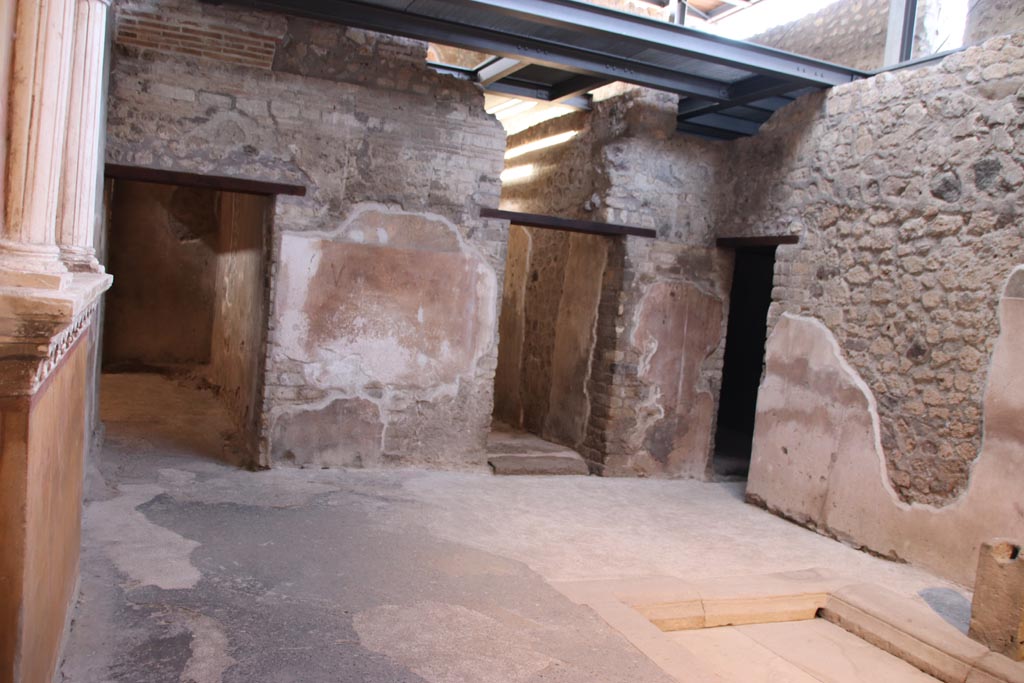 VI.15.1 Pompeii. October 2023. 
Looking towards north side of small atrium, with doorway to kitchen (w), on left, room (x) centre right, and room (z), on right. 
Photo courtesy of Klaus Heese.
