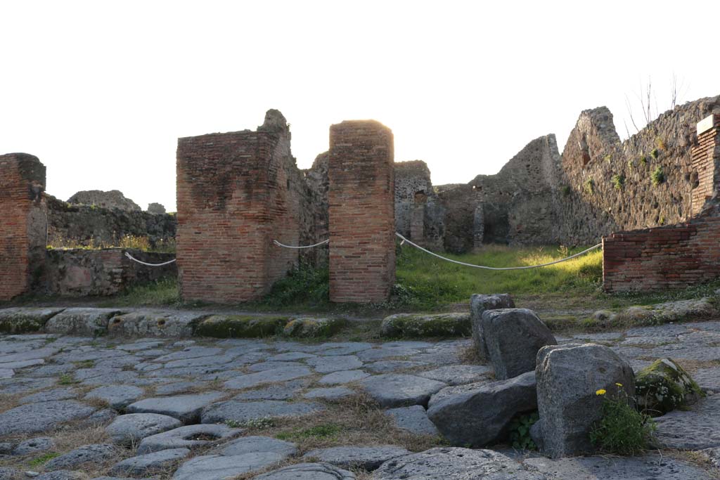 VI.15.16 Pompeii, on left. December 2018. 
Looking towards entrance doorways on west side of Vicolo dei Vettii. Photo courtesy of Aude Durand.
