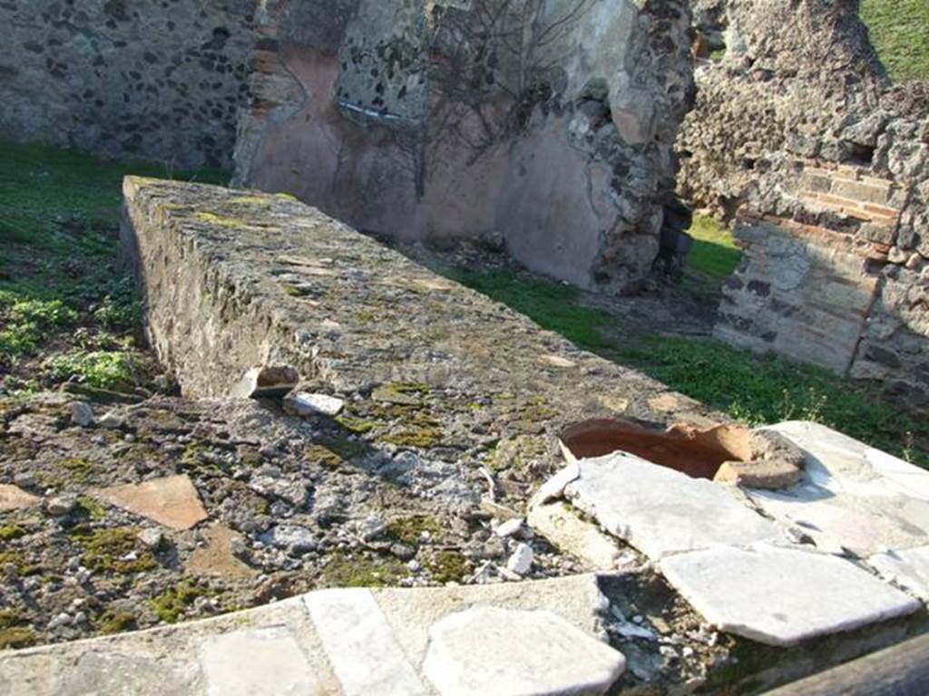 VI.15.16 Pompeii. December 2007. Looking west across remains of two-sided counter with one embedded dolium and a hearth.
