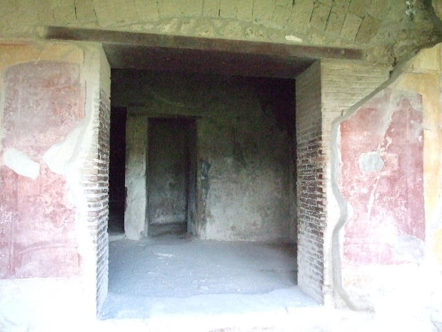 VII.1.8 Pompeii. May 2012. Detail of west wall at entrance to latrine O. Photo courtesy of Buzz Ferebee.