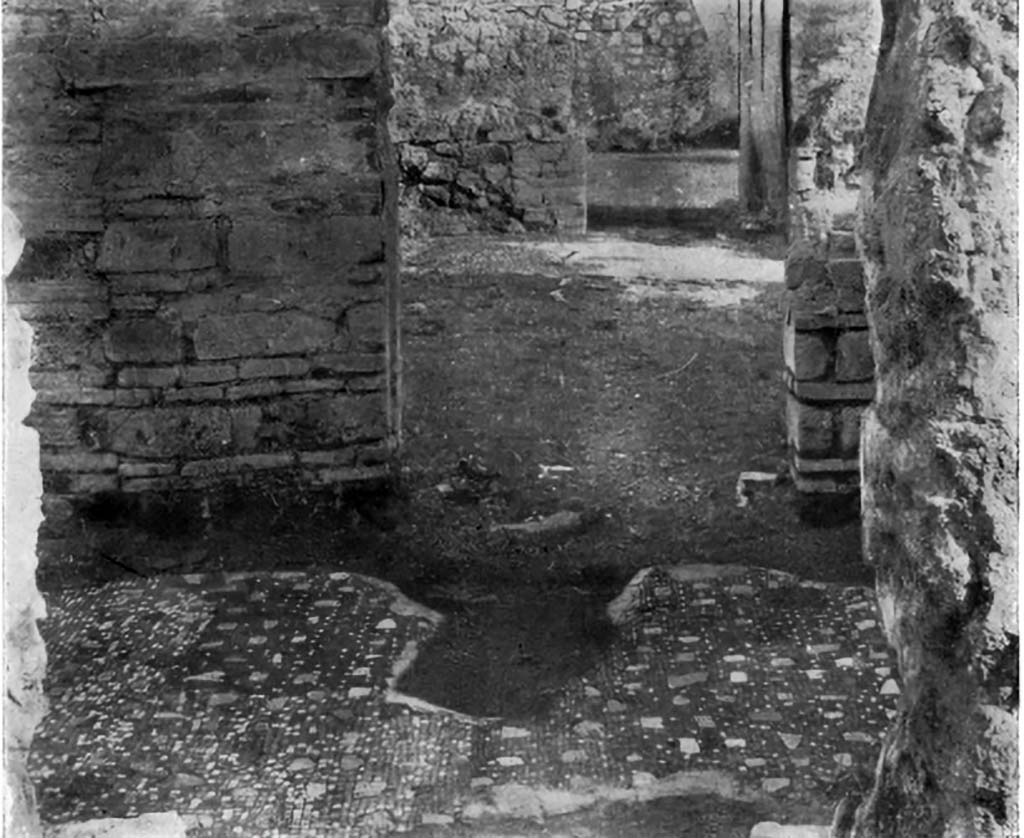 VII.6.3 Pompeii. c.1930.  
Looking east from corridor 17, across flooring of corridor 15, through doorway into tablinum 12 and across towards doorway to room 13.
The doorway to Room 14, and corridor 15 are on the left.
The doorway to Room 19, and stairway 16 would be on the right.
According to Blake, 
Only one other pavement employs limestone pieces alone to give colour to a black background.
In a corridor of VII.6.3 (pl.13, fig.4 above), the irregular pieces of coloured limestone have been retained, although the fine tesserae of the background
(0.7cm to 1cm) have been almost entirely replaced by coarser (1cm to 1.3cm).
See Blake, M., (1930). The pavements of the Roman Buildings of the Republic and Early Empire. Rome, MAAR, 8, (p.61, & pl.13, fig.4). 
