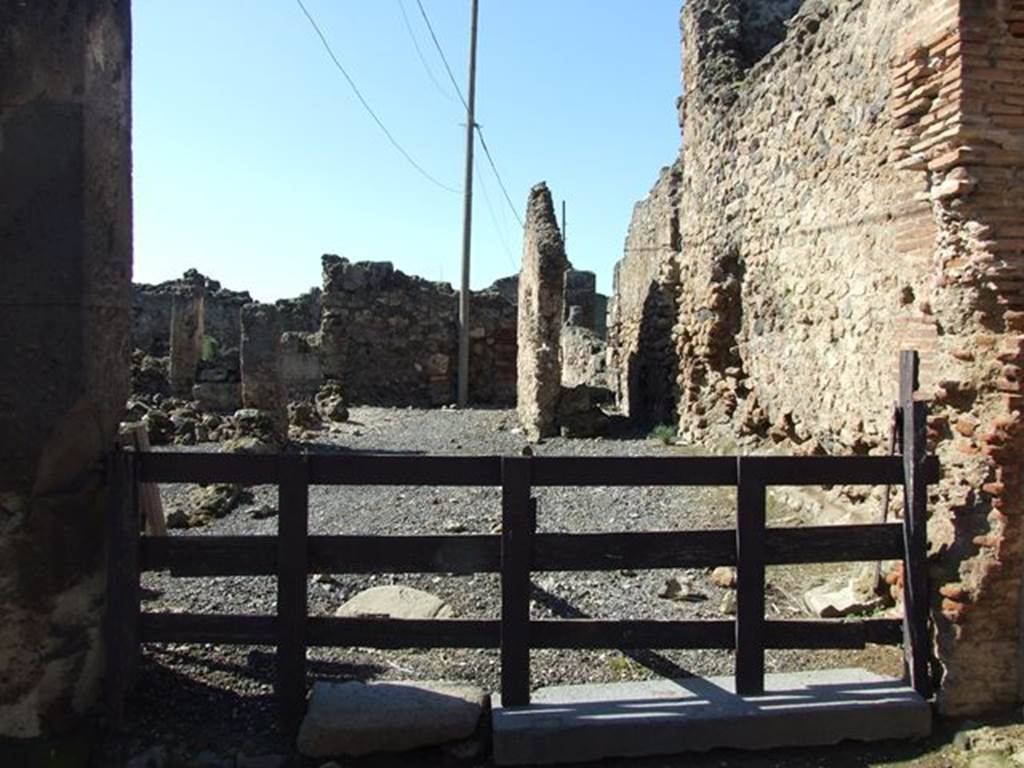 VII.6.19 Pompeii. March 2009. Looking west across workshop to rear.
According to Garcia y Garcia, this was very devastated and ruined following the September 1943 bombing, together with VII.6.20.
See Garcia y Garcia, L., 2006. Danni di guerra a Pompei. Rome: LErma di Bretschneider. (p.102). 
According to Della Corte, because of the considerable quantities of colouring materials and pigments found here, he considered it the workshop of an unknown and unnamed Negotiator Pigmentarius.
See Della Corte, M., 1965.  Case ed Abitanti di Pompei. Napoli: Fausto Fiorentino. (p.173)
