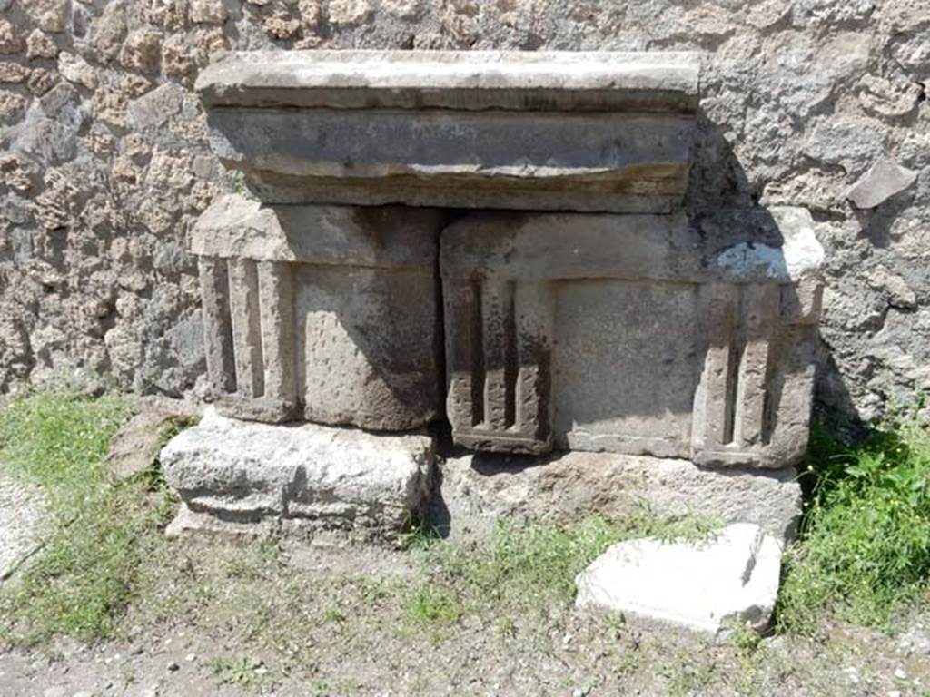 VII.7.32 Pompeii. May 2018. Stones against the west wall of Temple. Photo courtesy of Buzz Ferebee.
