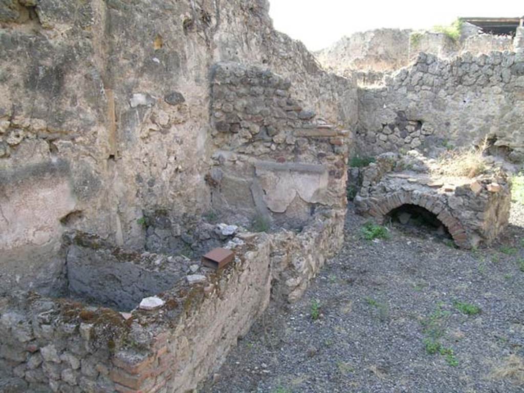 VII.12.23 Pompeii. June 2005. West side of rear room with hearth and three rectangular basins. Photo courtesy of Nicolas Monteix.