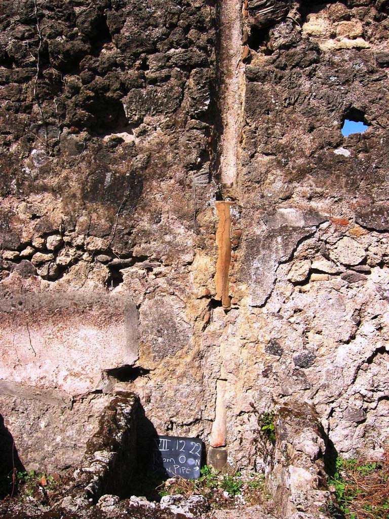 VII.12.23 Pompeii. July 2008. Downpipe in west wall of rear room. Photo courtesy of Barry Hobson.