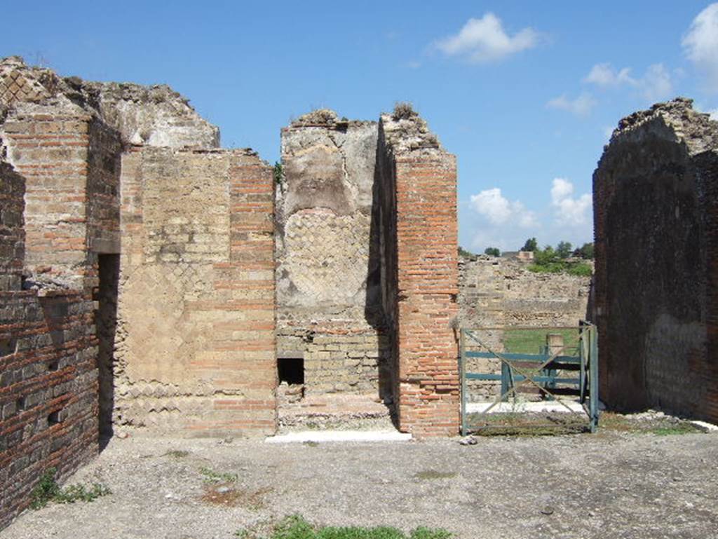 VIII.2.30 Pompeii. September 2005. Looking north in north-west corner of atrium, into doorway of kitchen, centre left. 
On the right is the entrance doorway from Vicolo della Regina.

