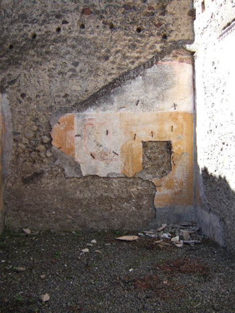 VIII.5.39 Pompeii. September 2005. Room 5, west wall.
According to PPM  The IV Style decoration is better preserved on this wall.
The central panel was white, the side panels were yellow edged with a border of carpet design; 
the one on the right (north end) contained a medallion showing the head of a young girl  now taken off
The zoccolo would have been black with painted plants.
See Carratelli, G. P., 1990-2003. Pompei: Pitture e Mosaici: Vol. VIII. Roma: Istituto della enciclopedia italiana, p. 659.
