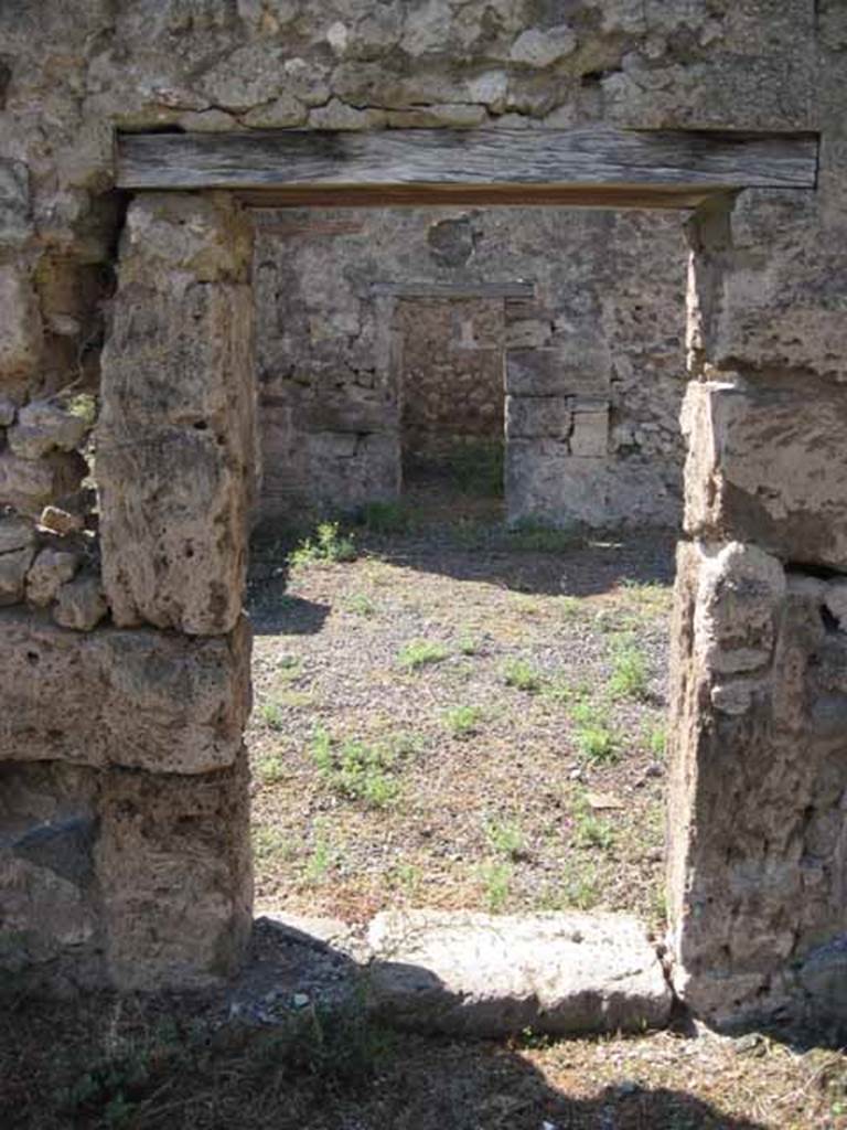 VIII.7.26 Pompeii. September 2010. Looking west through doorway from triclinium on east side of atrium. Photo courtesy of Drew Baker.
