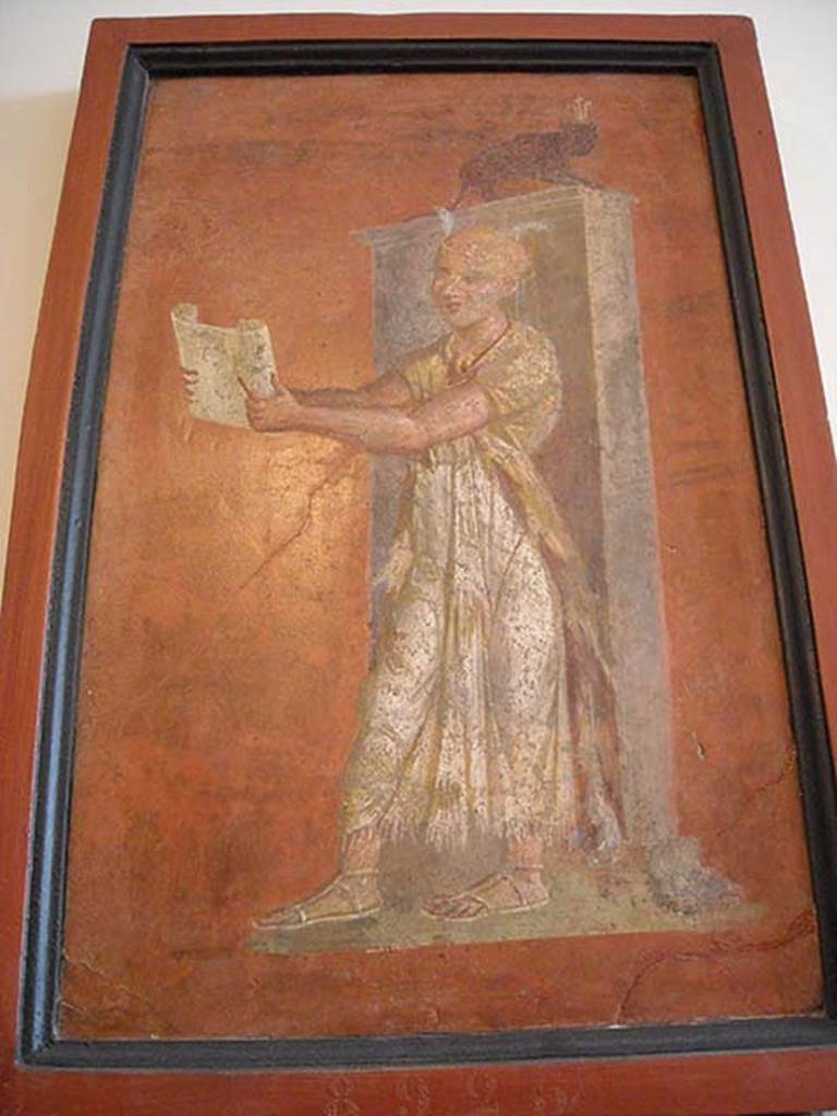 VIII.7.28 Pompeii. East part of north wall of portico. 
Priest reading ritual formulae from a papyrus scroll held in his hands. 
Now in Naples Archaeological Museum. Inventory number 8925.
