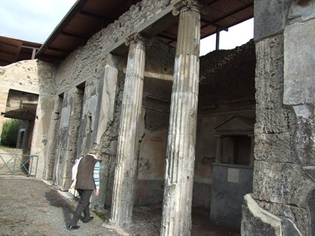 IX.1.20 Pompeii. December 2007. Room 2, atrium on east side, showing room 6, ala, with household shrine and 2 Ionic columns in opening.
