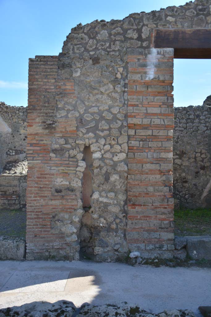 IX.5.8, on left, and IX.5.7, on right, Pompeii. March 2017. 
Looking south to pilaster between two entrance doorways, with terracotta downpipe. 
Foto Christian Beck, ERC Grant 681269 DCOR.
