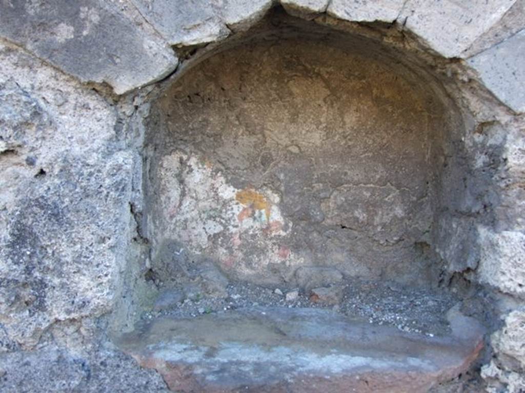 IX.9.a/2 Pompeii. March 2009. Remains of painting are visible in the niche.  
In the floor of the niche is a hole for the base of a statue.
See Giacobello, F., 2008. Larari Pompeiani: Iconografia e culto dei Lari in ambito domestico.  Milano: LED Edizioni. (IX.9.2:110, p.213).
See Boyce G. K., 1937. Corpus of the Lararia of Pompeii. Rome: MAAR 14.  (p.90-91, no. 454)

