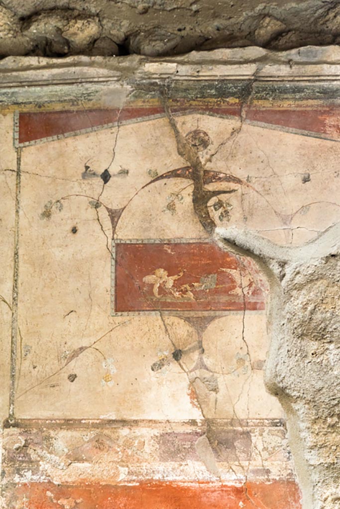 IX.9.c Pompeii. March 2023. 
Detail of painted panel showing cupid fallen from chariot from upper centre of east wall. 
Photo courtesy of Johannes Eber.
