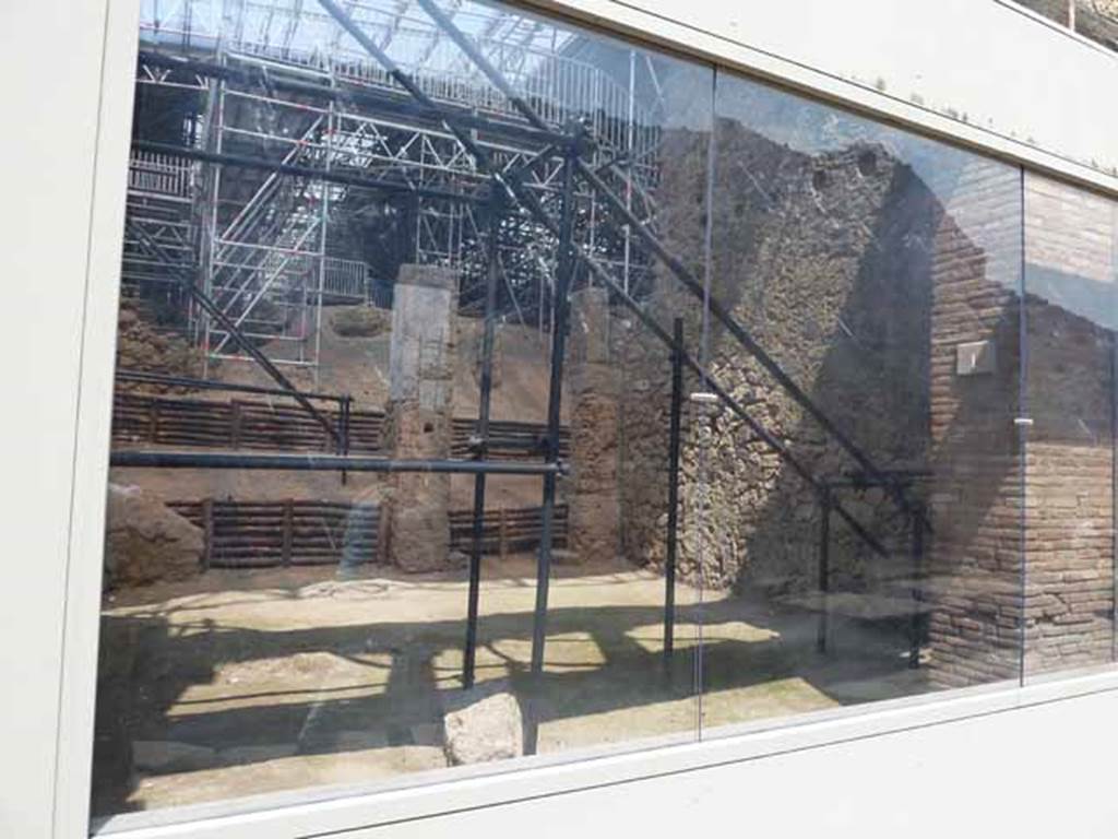 IX.12.2 Pompeii.  May 2010. Looking through glass front across IX.12.1 to site of stairs, against east wall, on right.