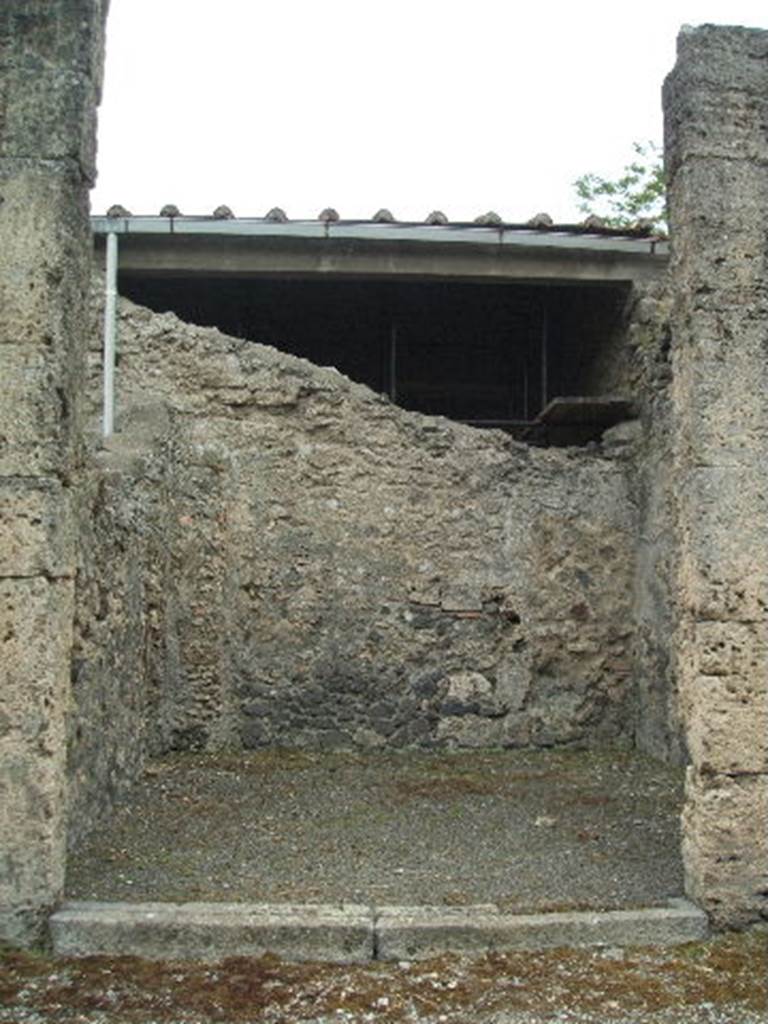 IX.14.3 Pompeii. May 2005. Entrance doorway, looking south.
According to Eschebach, in the left wall (east) was a lararium niche.
Behind this was a latrine with a downpipe from above, and on the rear wall were the steps to the upper floor.
See Eschebach, L., 1993. Gebudeverzeichnis und Stadtplan der antiken Stadt Pompeji. Kln: Bhlau. (p.451)
According to Boyce, in the east wall was a square niche painted white within. Not. Scavi, 1911, 351.  Boyce gives the location as Reg. III, Taberna located to the east of the entrance into the smaller atrium of Domus Obelli Firmi. See Boyce G. K., 1937. Corpus of the Lararia of Pompeii. Rome: MAAR 14. (p.31, no.69) 

