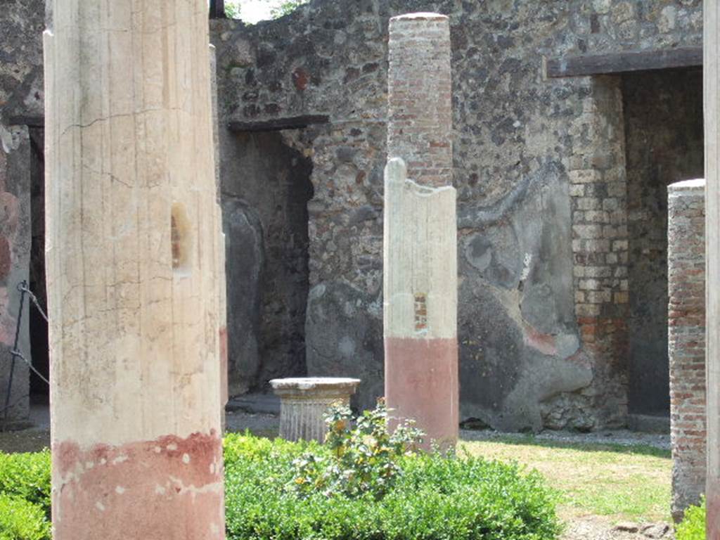 HGW24 Pompeii. May 2006. Looking across peristyle towards west wall, with doorways to stairs and small cupboard.