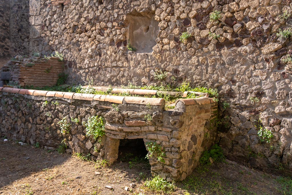 Villa of Mysteries, Pompeii. October 2023. 
Room 61, west wall with hearth and oven, and remains of niche. Photo courtesy of Johannes Eber.
