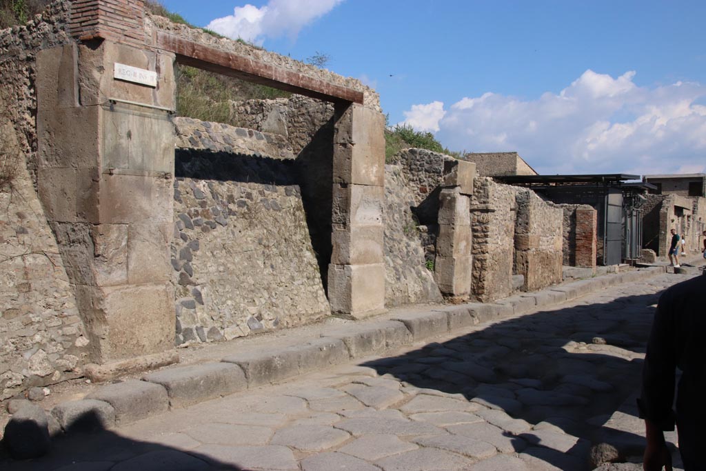 Via dell’Abbondanza, north side, Pompeii. October 2022. 
Looking east from III.3.1 towards III.3.6 and Vicolo di Ifigenia, on right. Photo courtesy of Klaus Heese

