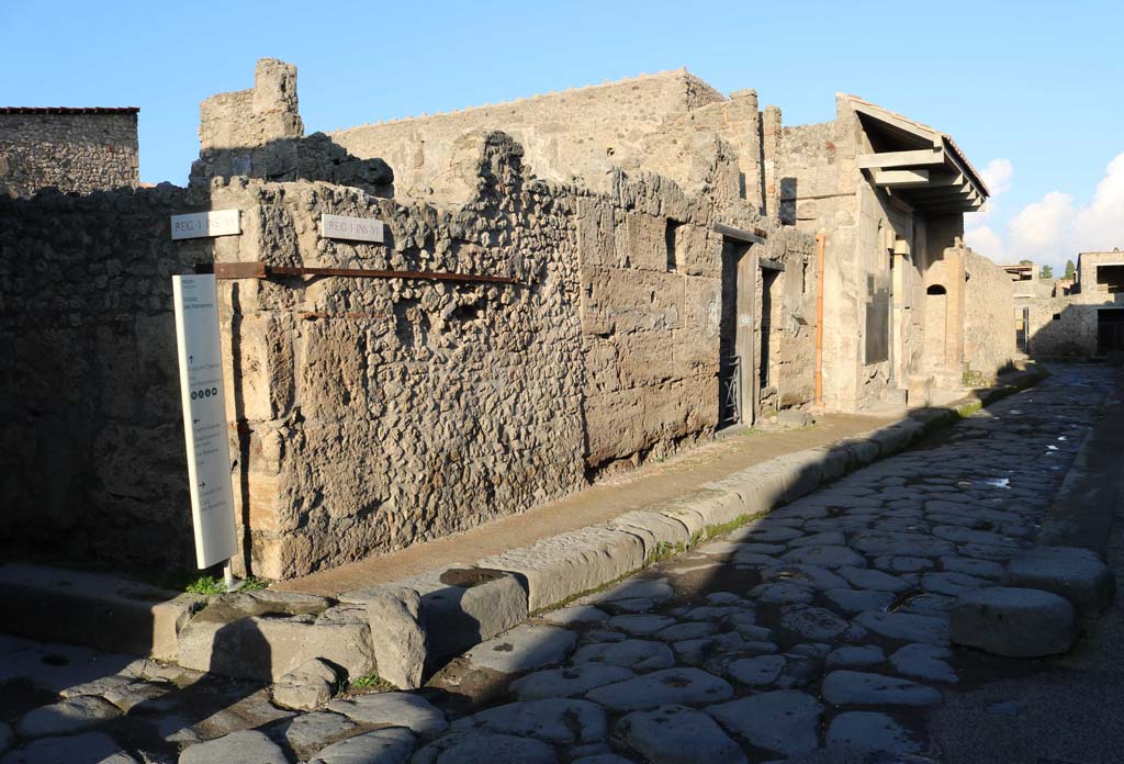 Vicolo del Menandro, north side, Pompeii. December 2018. 
Looking east from junction with Vicolo del Citarista, on left, towards I.6.13  1.6.16. Photo courtesy of Aude Durand.
