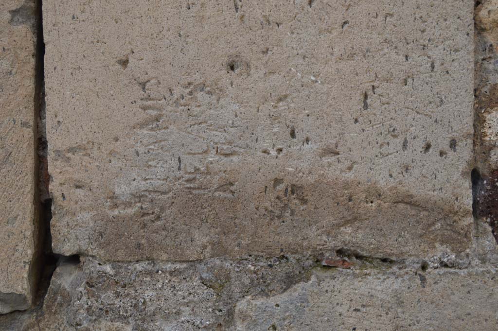 Vicolo degli Scheletri, Pompeii. March 2018. 
Looking south to detail of inscribed stonework on corner of VII.13, at junction with Vicolo della Maschera. 
Foto Taylor Lauritsen, ERC Grant 681269 DÉCOR.
